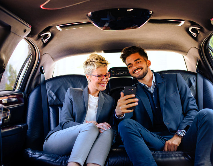 happy female and male passenger inside the car