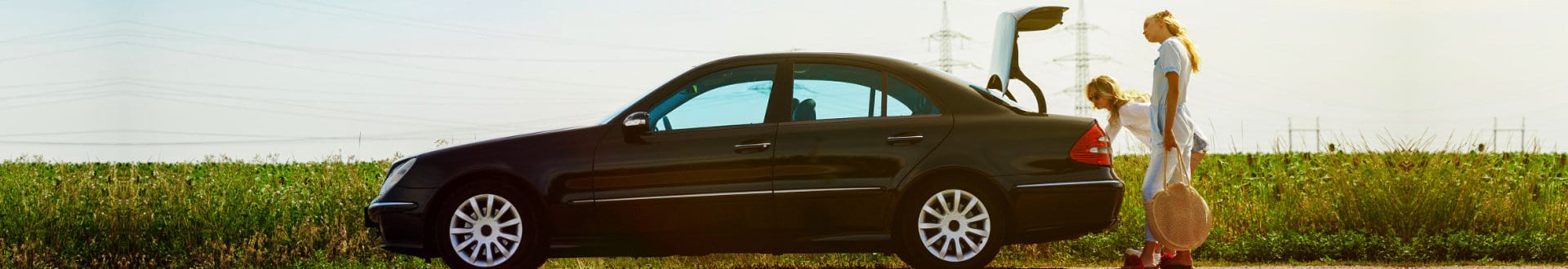 female driver putting the things of passenger at the back of car